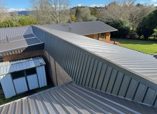 After: the same home with a new dark long-run roof