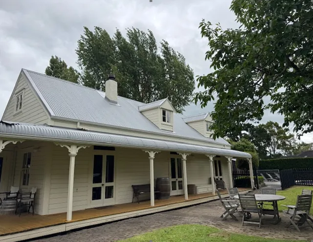 After: the same villa with a new light long-run roof